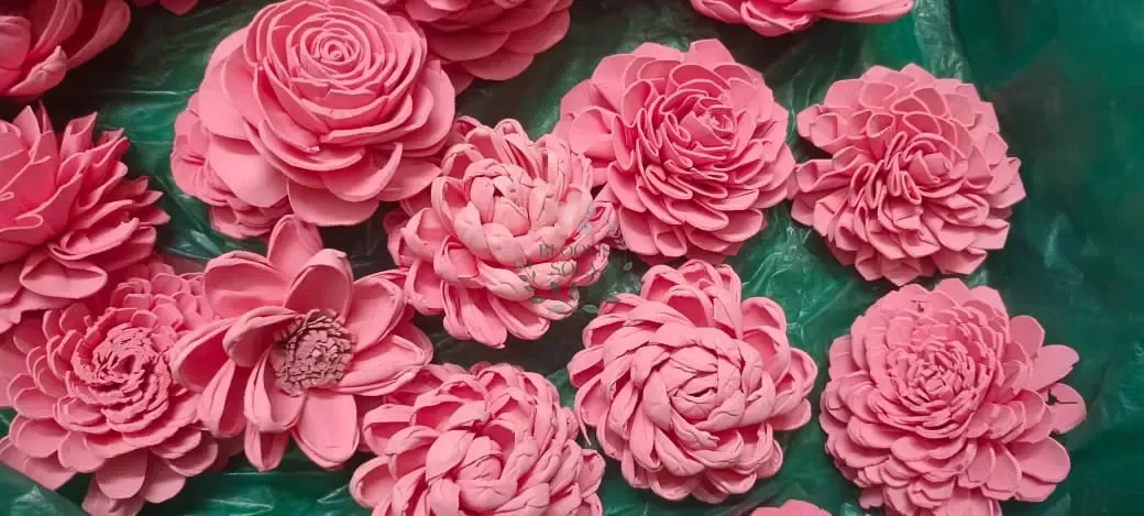 Artisan shaping sola wood flower petals by hand